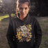 This hoodie features a beautifully detailed owl perched on a branch, surrounded by a scattering of warm-toned autumn leaves.